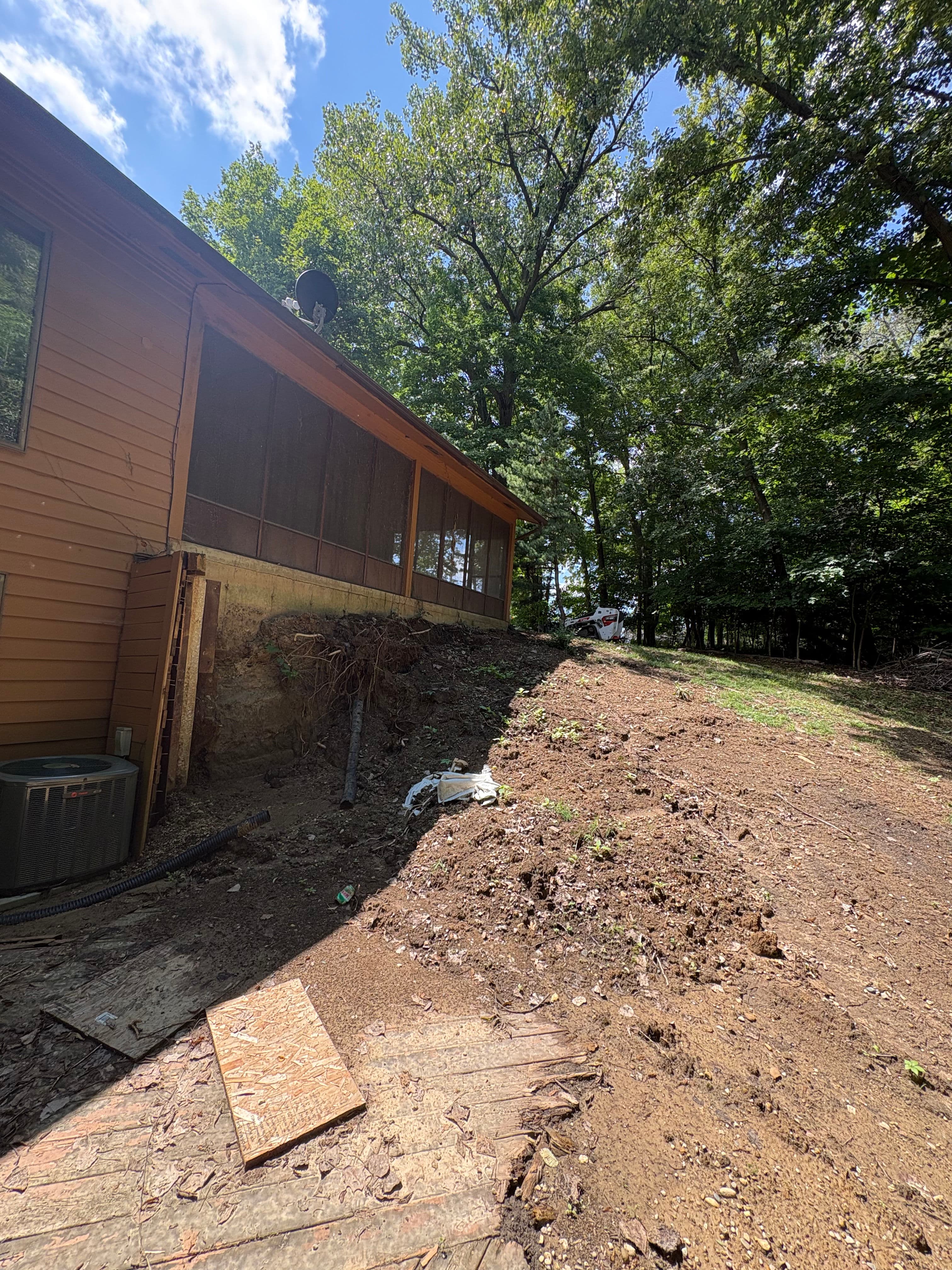 Project Retaining Wall and Drainage Fix Along a Sloped House Foundation image